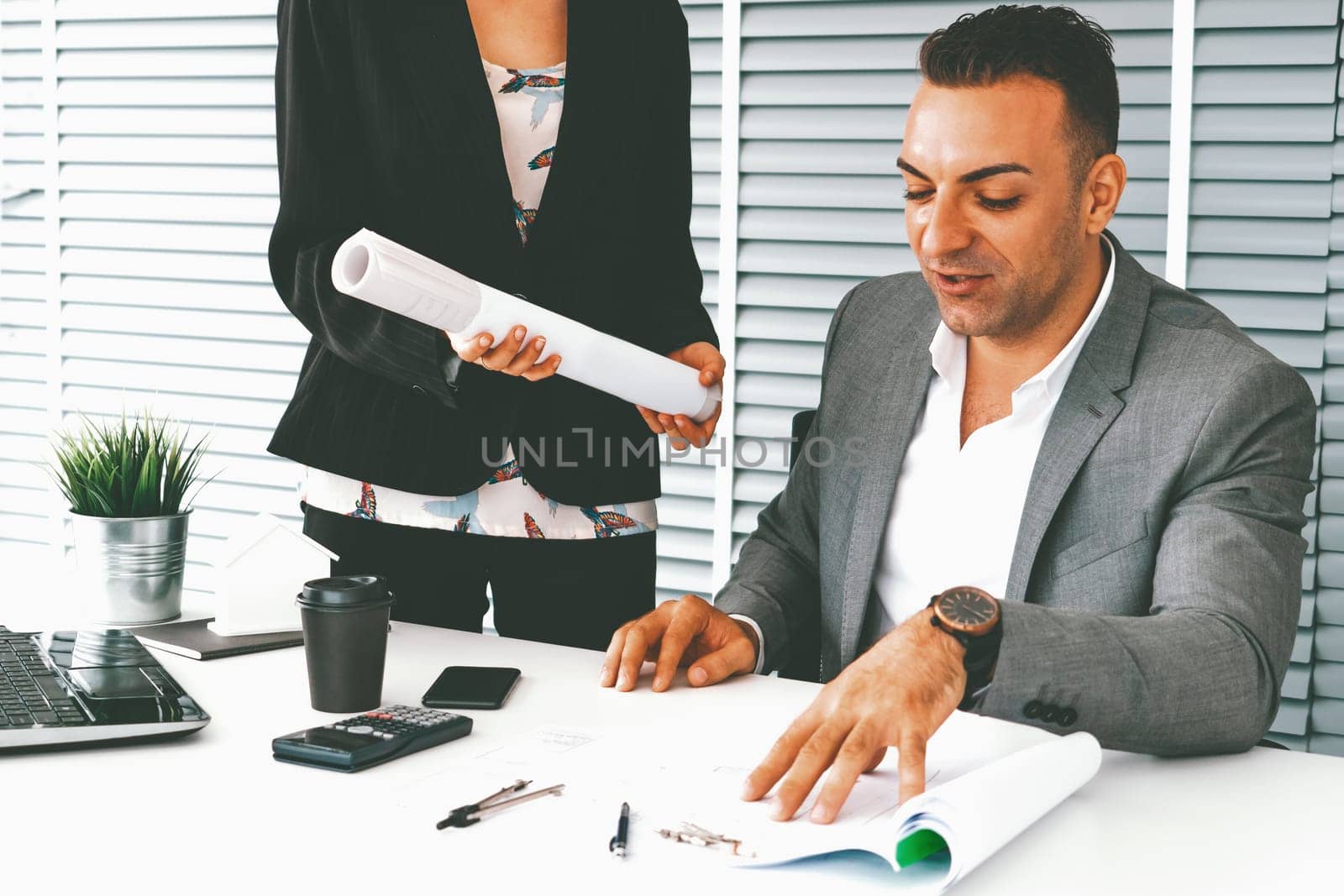 Businessman executive checking work while meeting discussion with businesswoman worker in modern workplace office. People corporate business team concept. uds