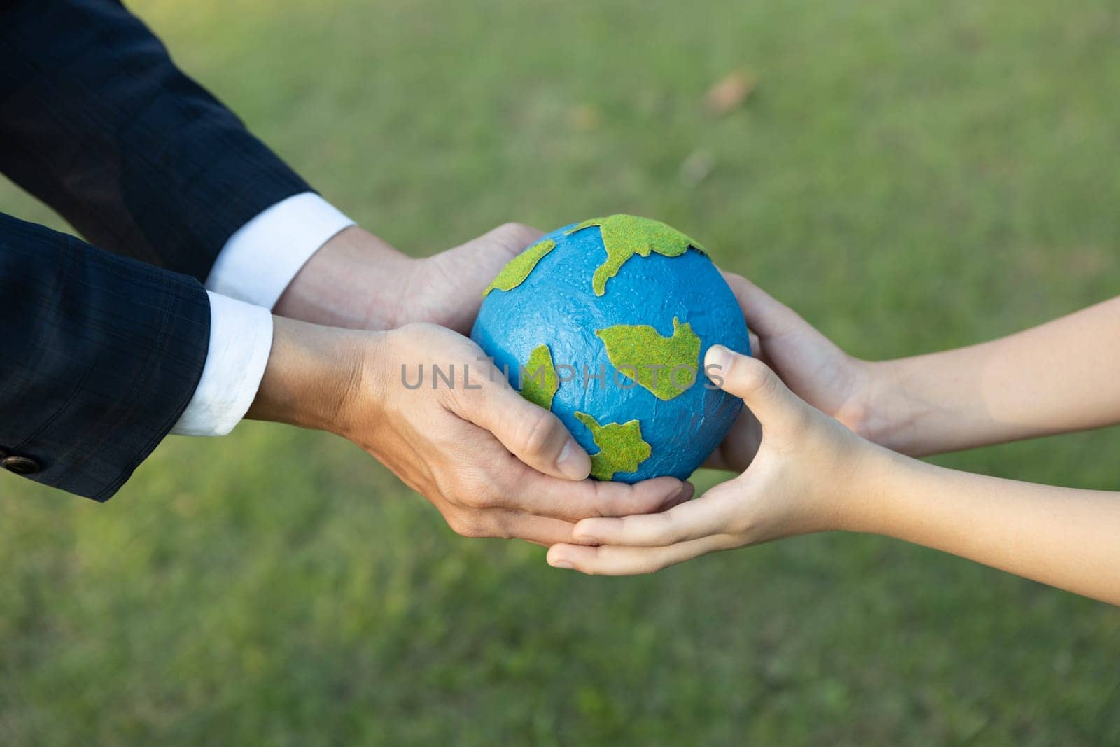 Businessman hand giving Earth globe to little boy as Earth day concept. Gyre by biancoblue