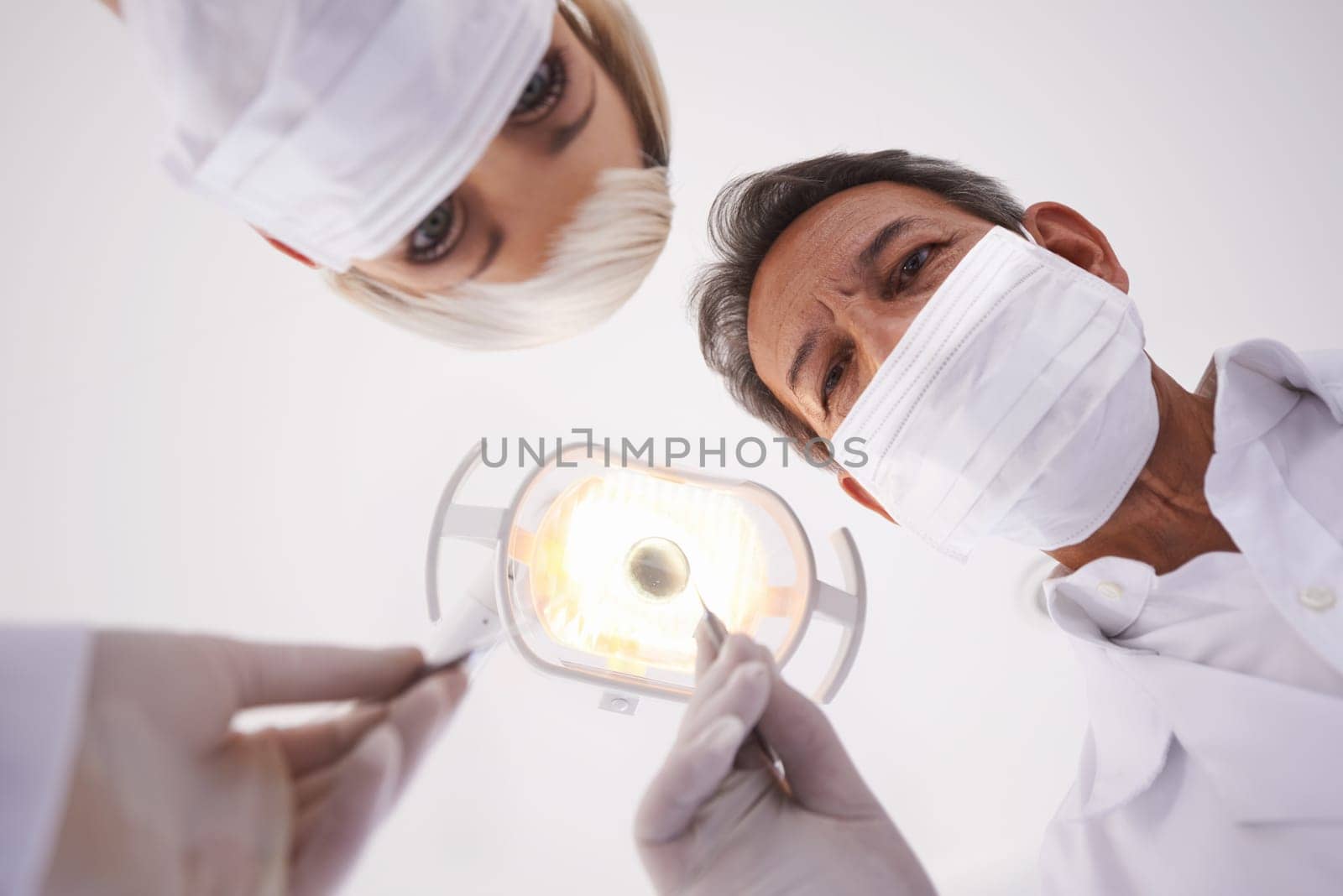 Dentist, team and portrait of people with light for consulting, teeth whitening and wellness. Healthcare, dentistry and man and woman with tools for dental hygiene, oral care and medical services by YuriArcurs