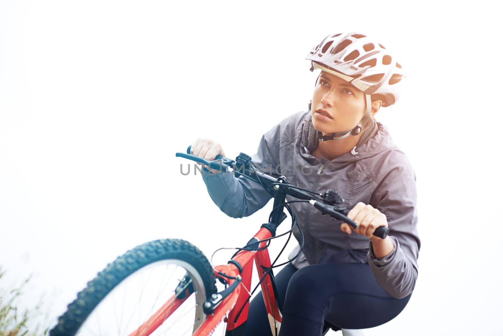 Woman, bike and nature with cycling, workout and fitness for health and wellness or speed. Athlete, ride and exercise for training, transportation and adventure with helmet and cardio or perseverance.