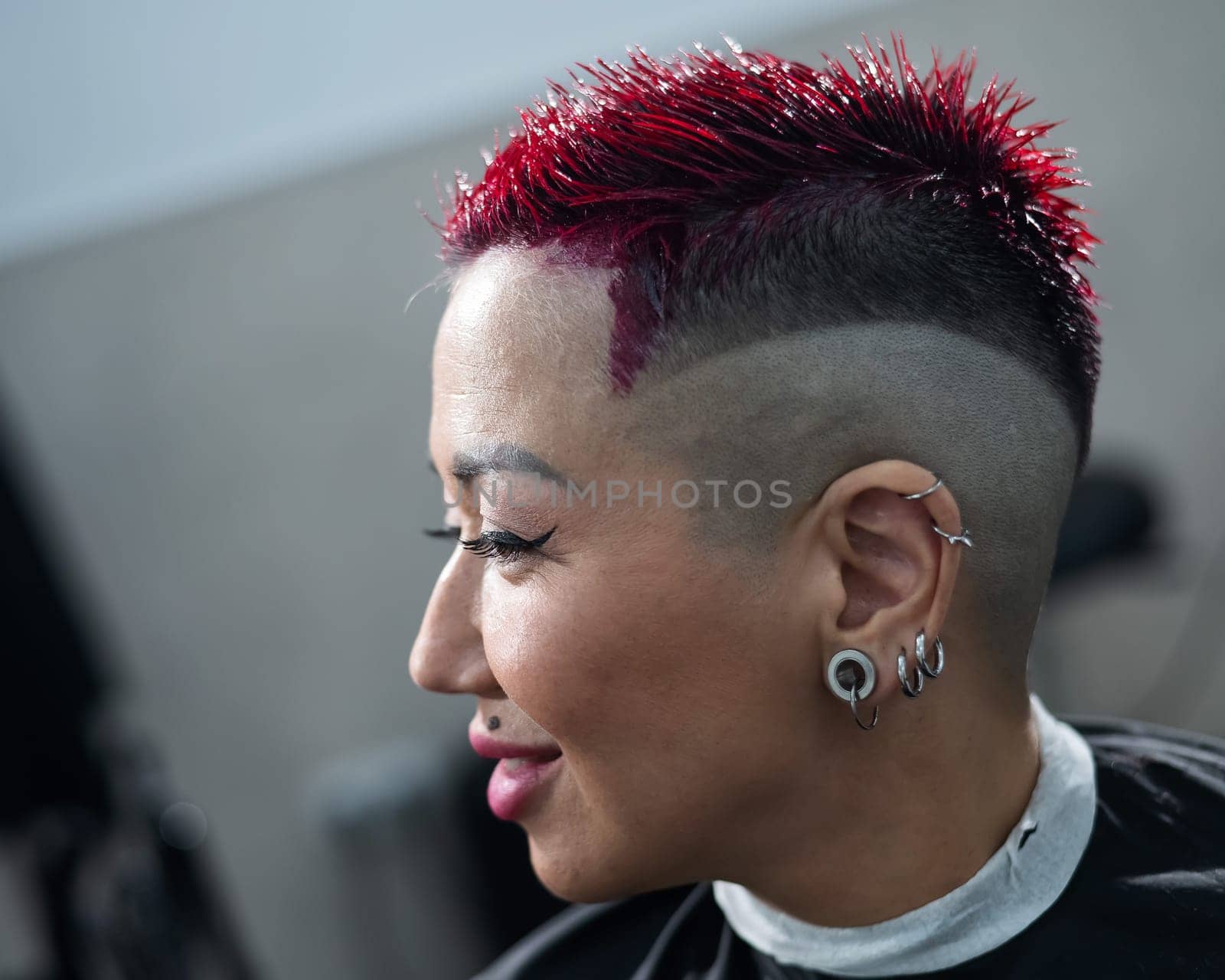 Asian woman dyeing her hair pink at the barbershop. by mrwed54
