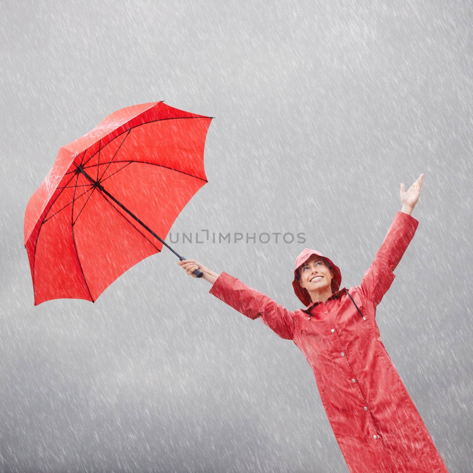 Woman, rainfall and umbrella for protection, outdoor nature and security from rain in weather. Female person, insurance and safety or shield from storm, winter and travel for holiday or vacation by YuriArcurs