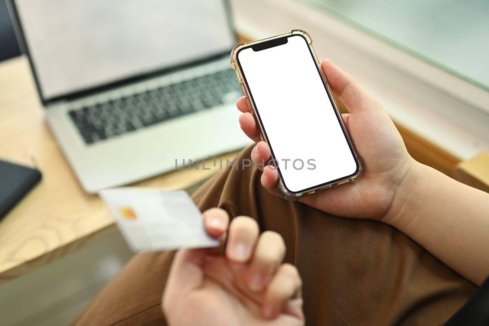 Man holding smartphone with blank empty screen and credit card. Closeup view.