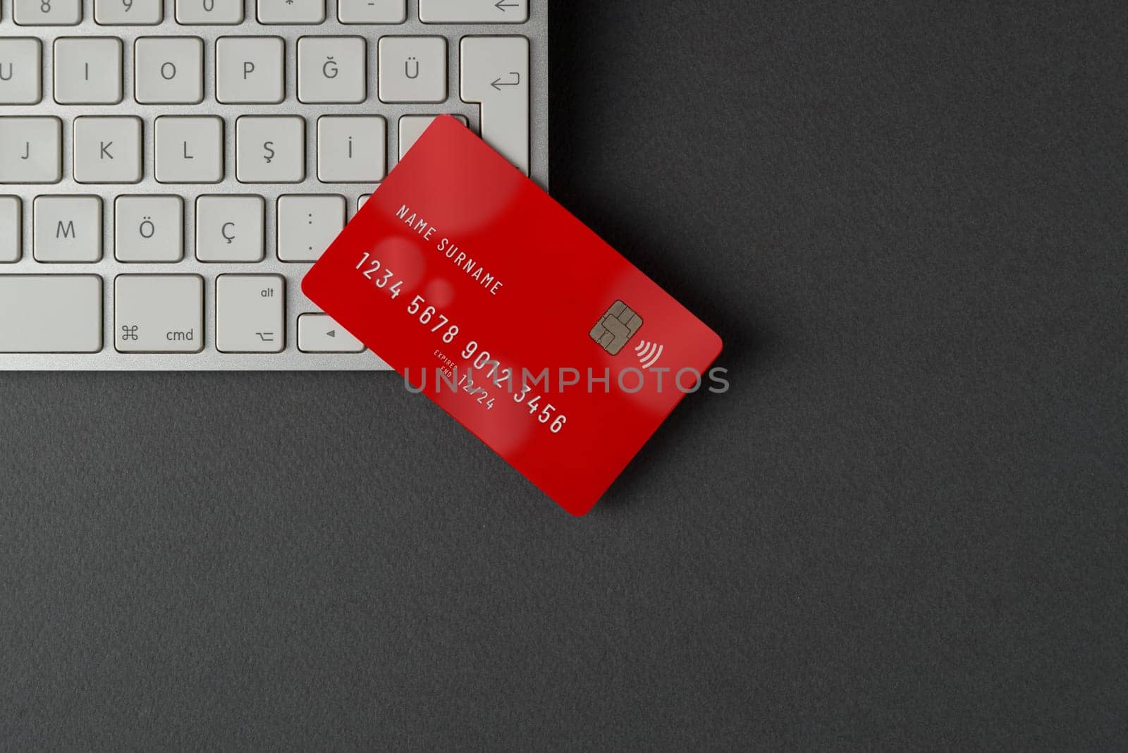 Top view of computer keyboard and credit card on dark gray table