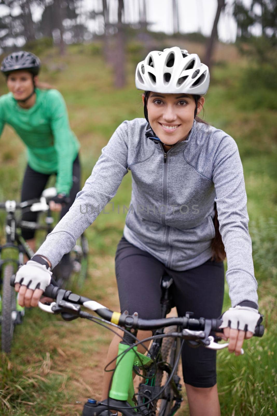 Happy woman, portrait and friends with bicycle in nature for fitness, cycling or off road travel on trail. Female person, rider or biker with smile in forest for outdoor workout or sports exercise by YuriArcurs