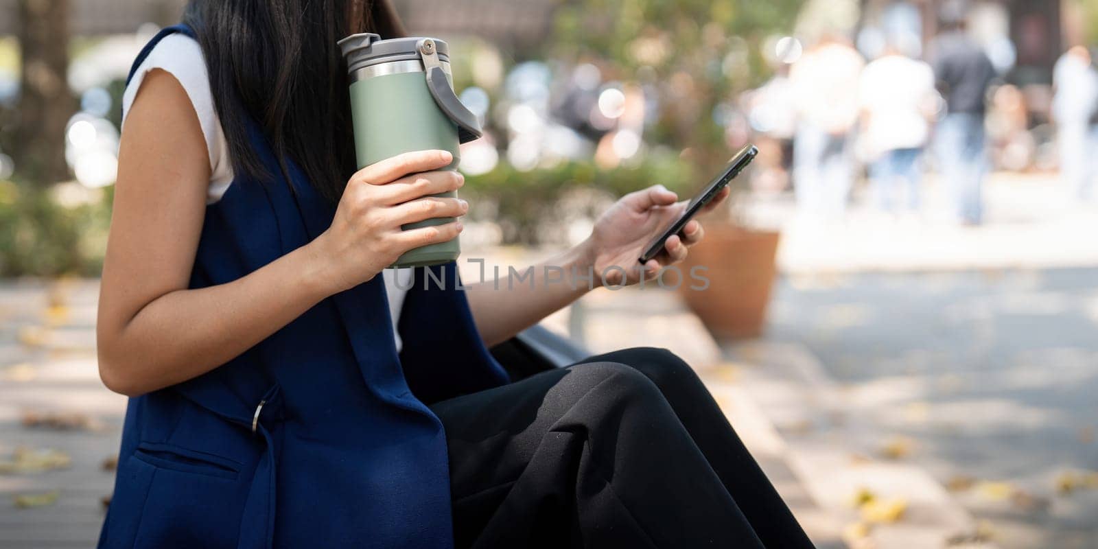 Asian businesswoman hold reusable eco friendly ecological cup while commuting in office.