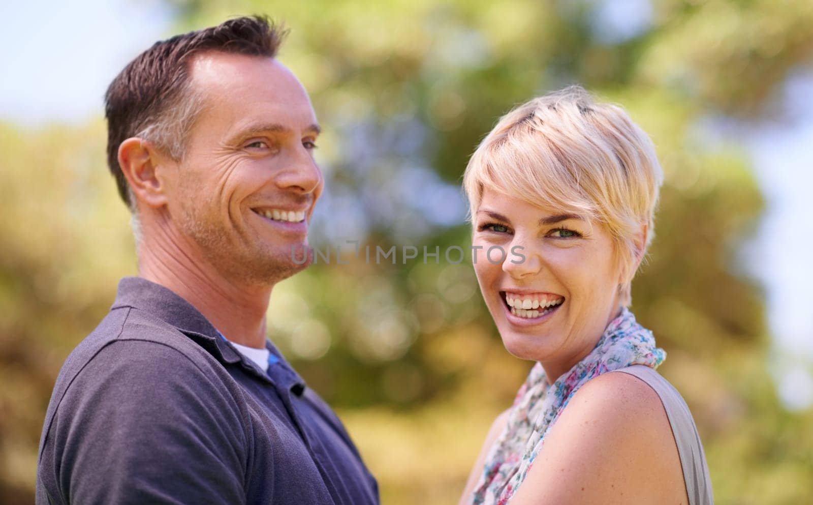 Portrait, couple and love with smile in outdoor in happiness, affection and romance for date. Park, relationship and together with bonding for care, satisfied and trust with commitment and support.