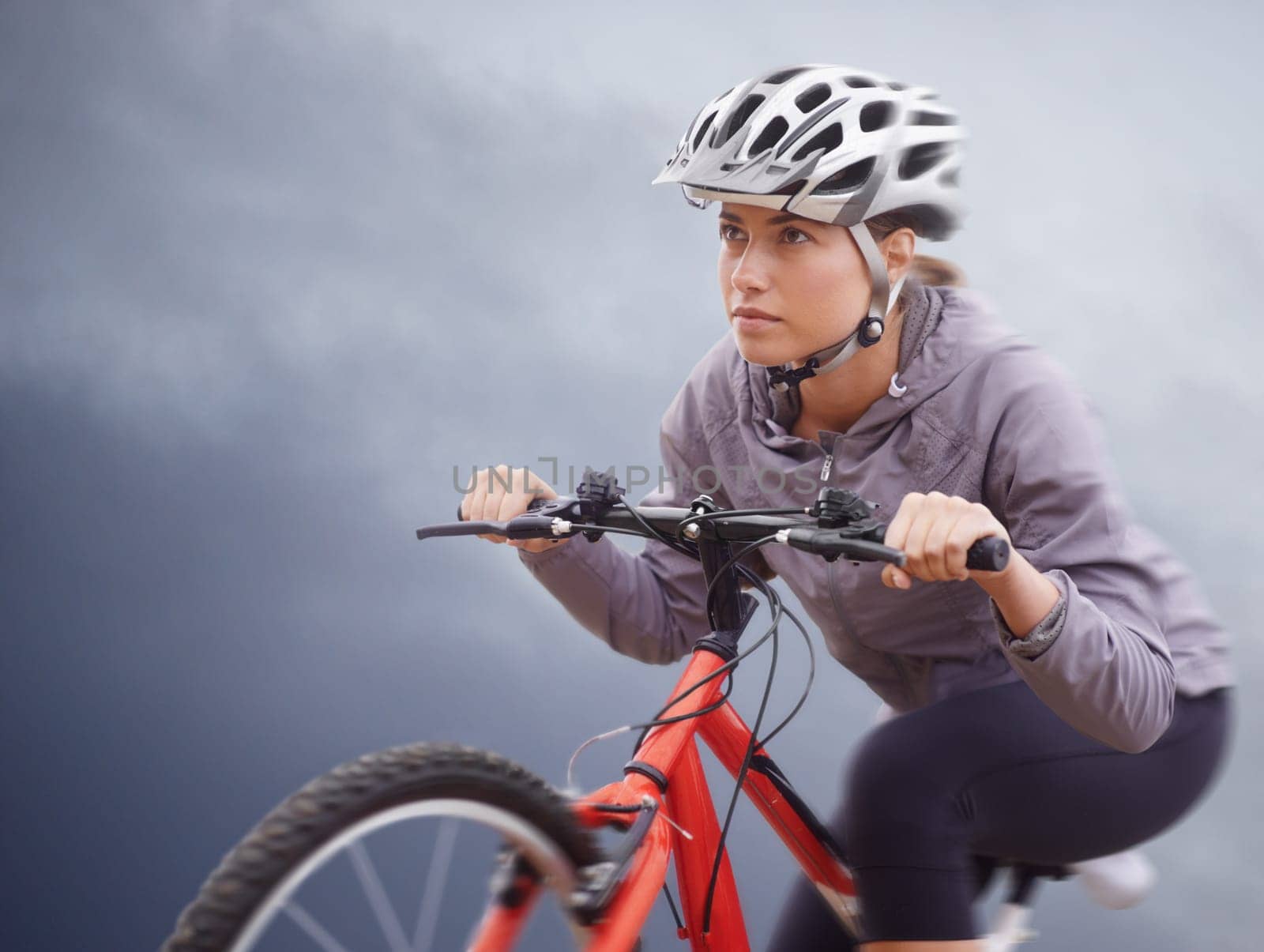 Woman, bike and nature with cycling, speed and fitness for health and wellness or workout. Athlete, ride and exercise for training, transportation and adventure with helmet and cardio or confidence.