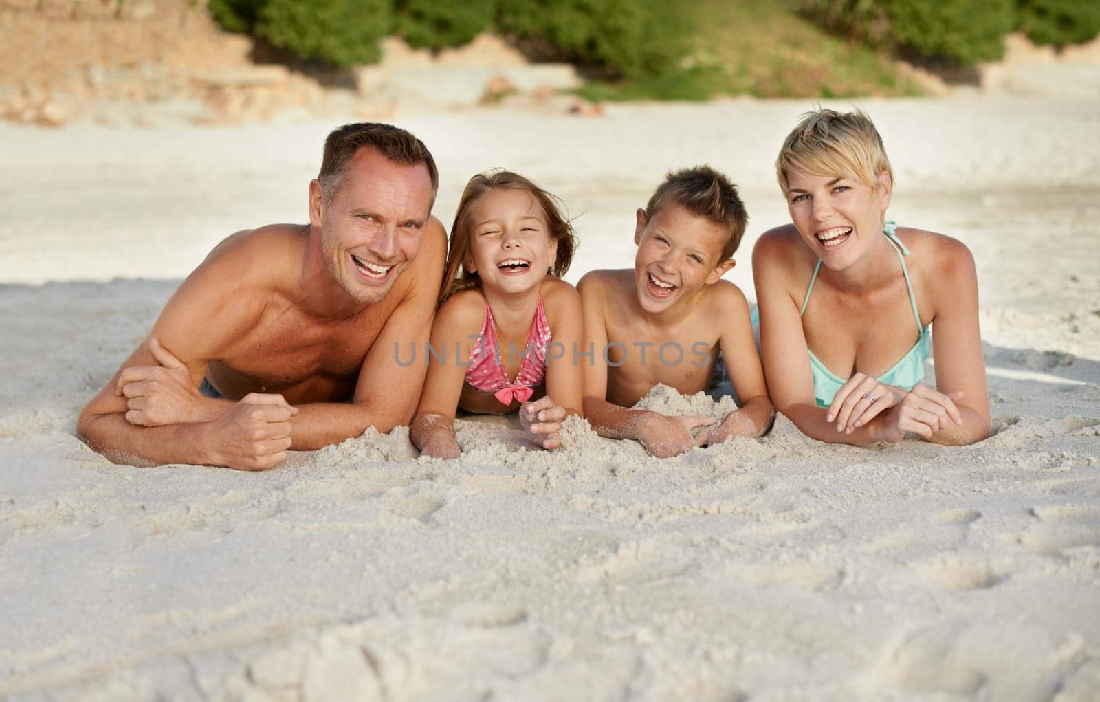 Parents, children and beach with adventure in summer on vacation for bonding and happiness in Florida. Family, smile and travel for holiday with kids to relax, fun and enjoy trip in seaside