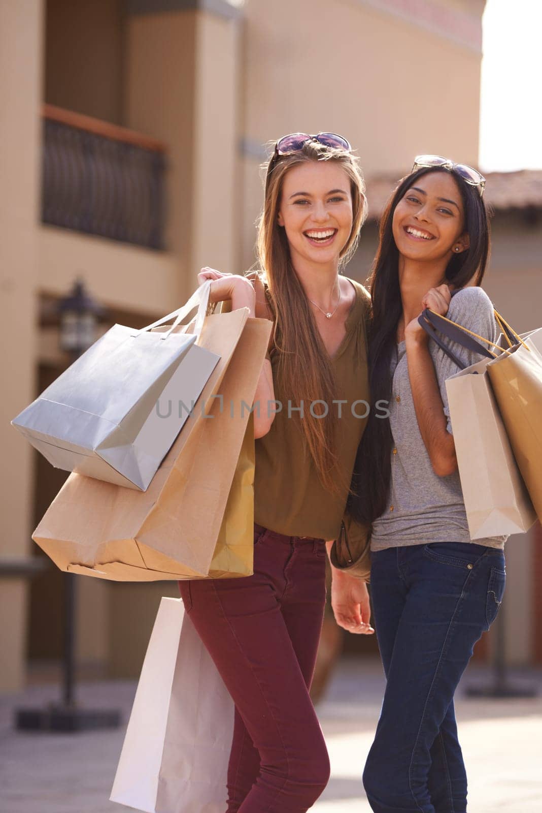 Women, happy and shopping bag in city for fashion, sale and discount with portrait outdoor in Europe. Young people or friends with smile and diversity for retail purchase, travel and style or clothes.