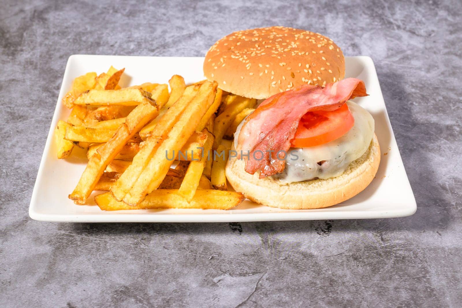 hamburger plate with egg,bacon and french fries,