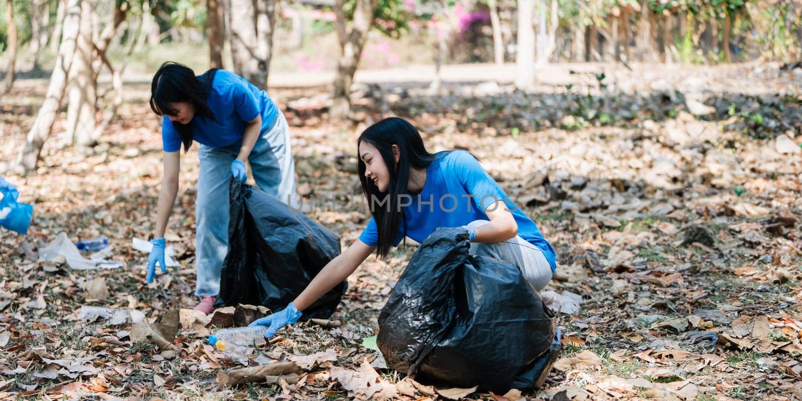 Group of volunteers, community members cleaning the nature from garbage and plastic waste to send it for recycling by itchaznong