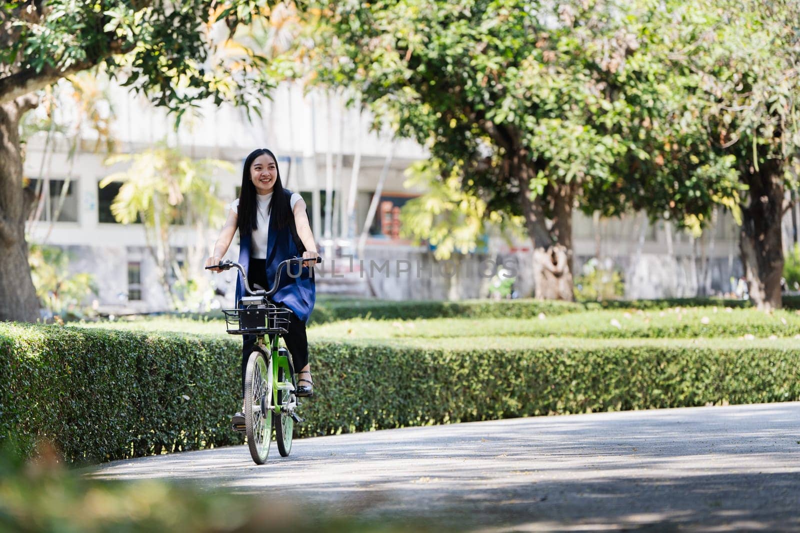 Professional Business woman with bike in the morning walking in the street to work. Eco friendly by itchaznong