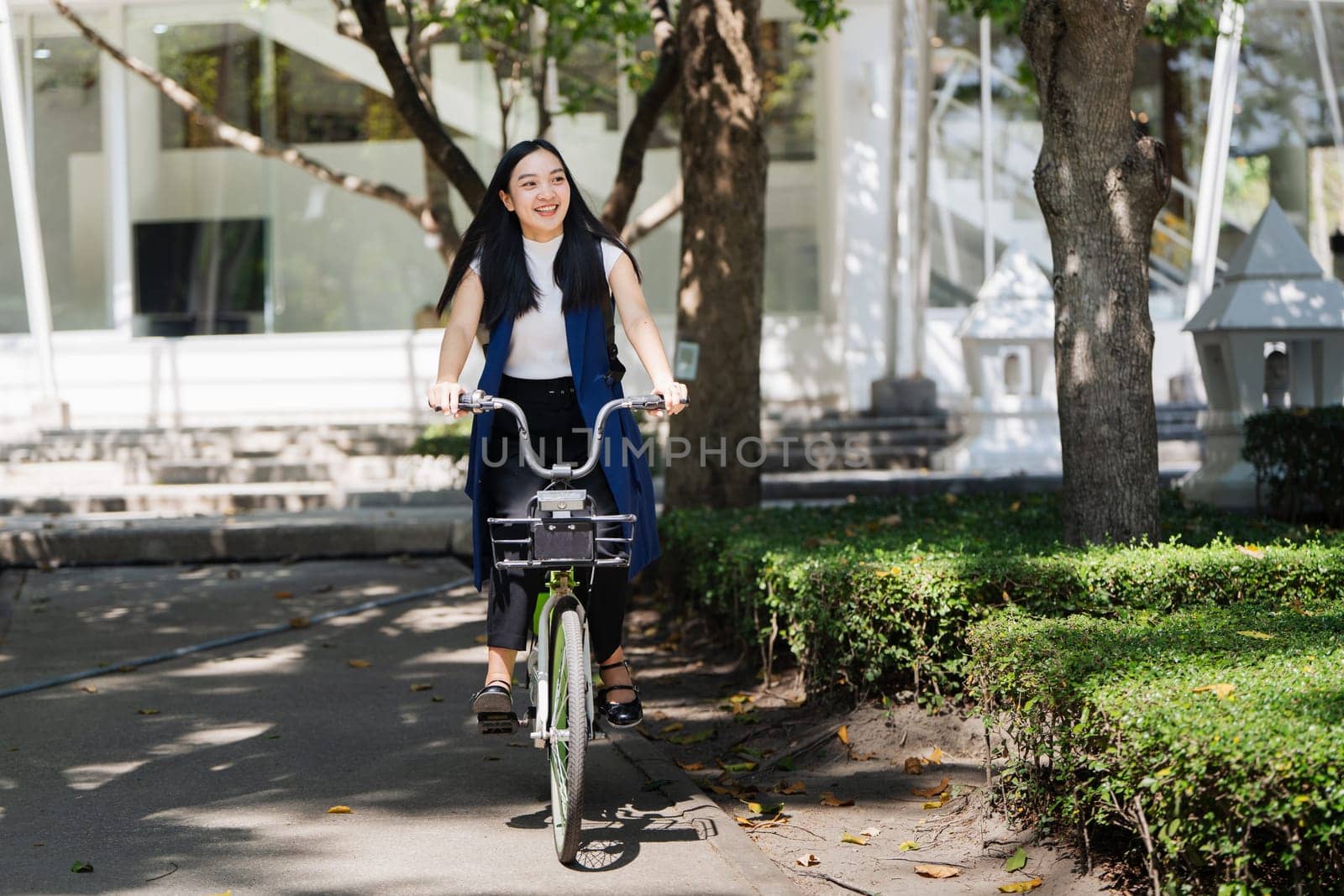 Professional Business woman with bike in the morning walking in the street to work. Eco friendly by itchaznong