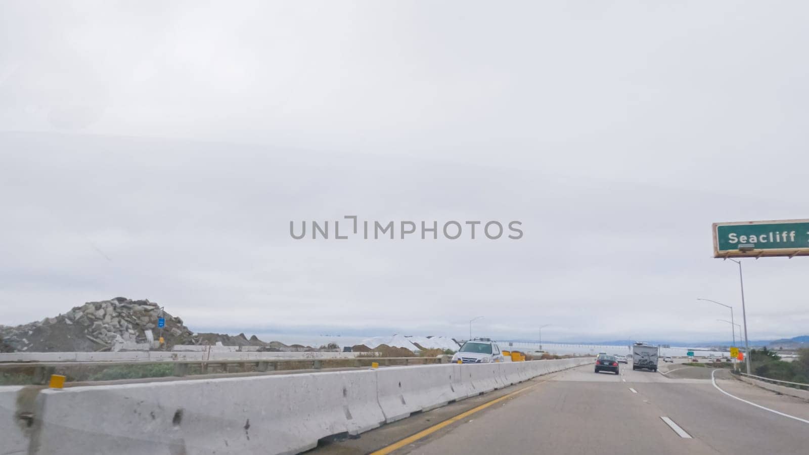 Los Angeles, California, USA-December 4, 2022-POV-Driving along Highway 101 near Rincon Beach, California, amidst a gloomy, cloudy winter day.