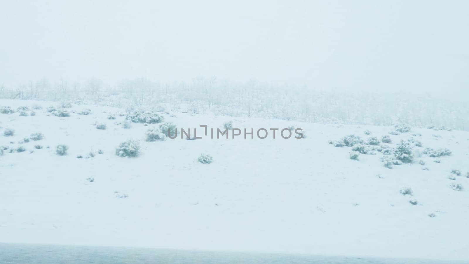 POV-Electric vehicle is captured deftly navigating the I-70 highway during a winter storm in Western Colorado.