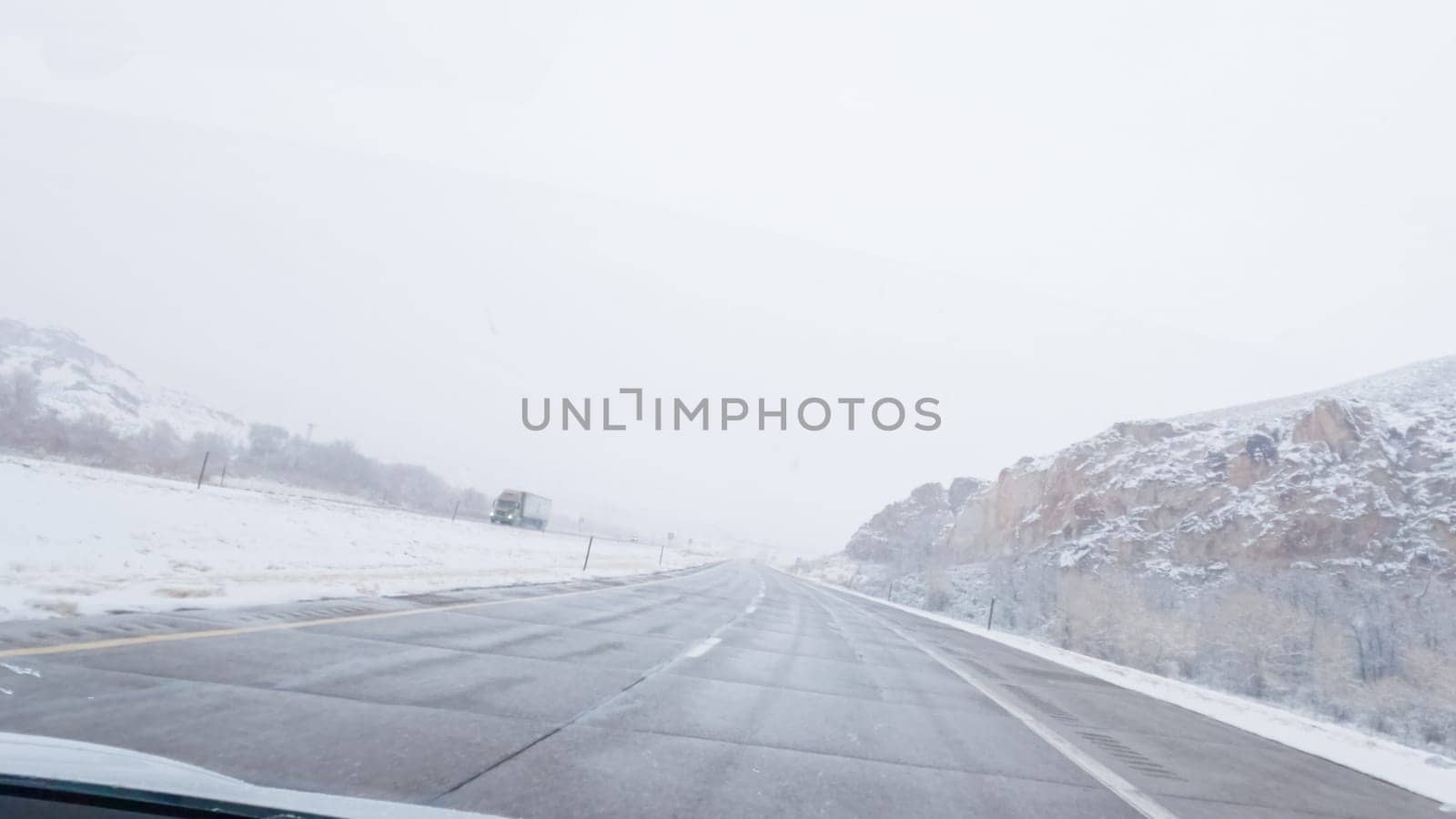 POV-Electric vehicle is captured deftly navigating the I-70 highway during a winter storm in Western Colorado.