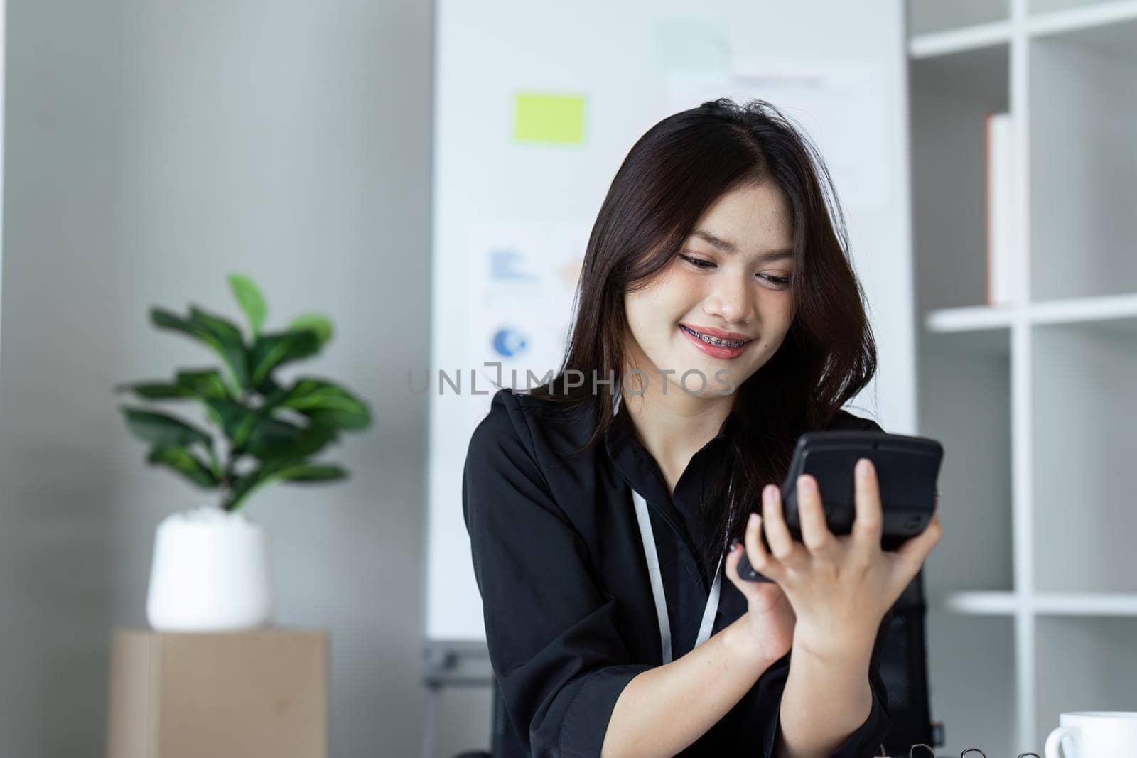Businesswoman working with document and using calculator for checking finance report by itchaznong