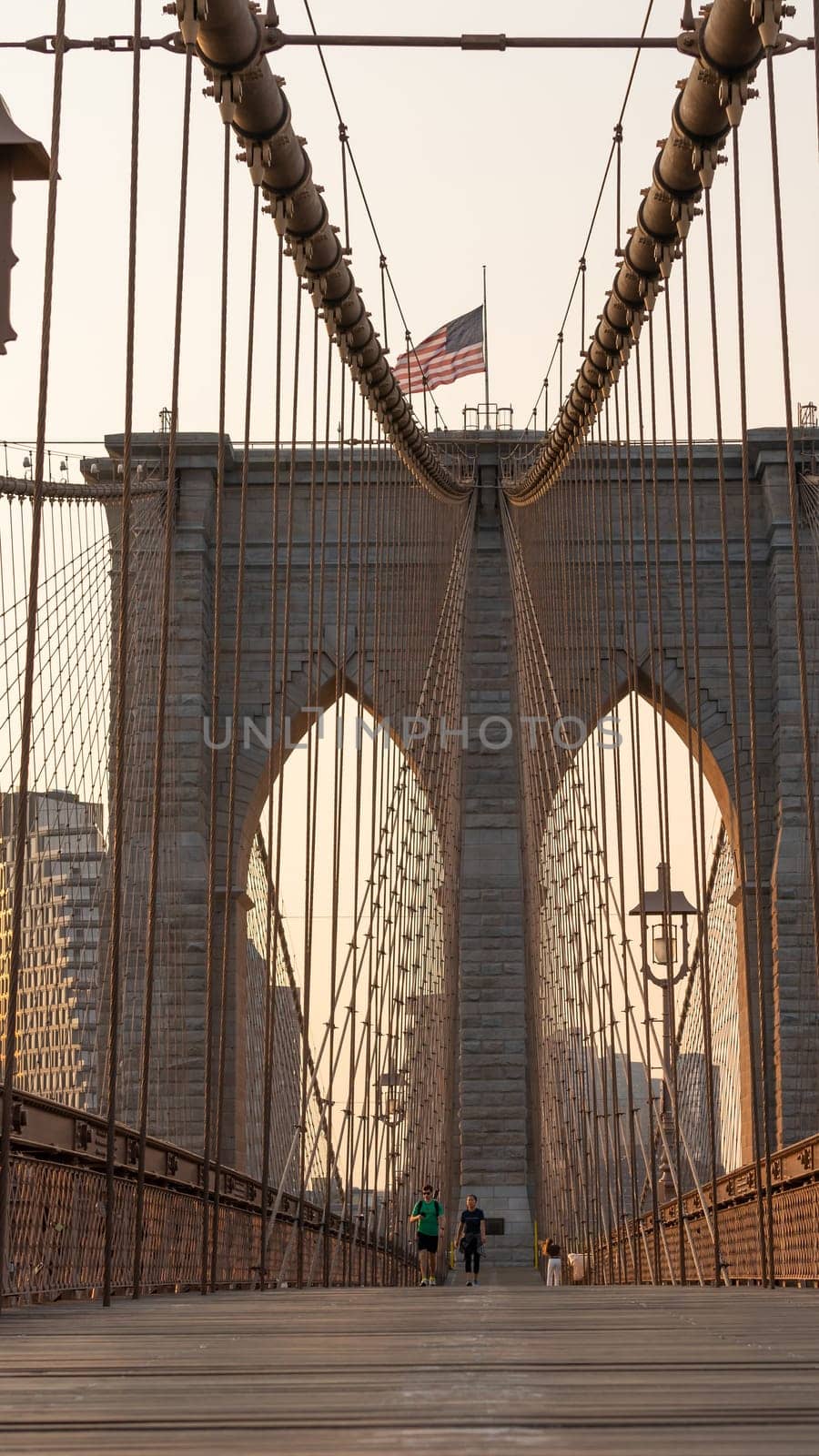 New York City, United States - September 18, 2022. People walk under the arch of the Brooklyn