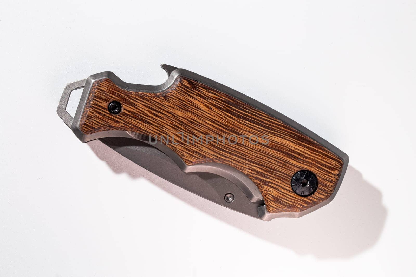 Elegant pocket knife with wooden handle on white background by Pukhovskiy