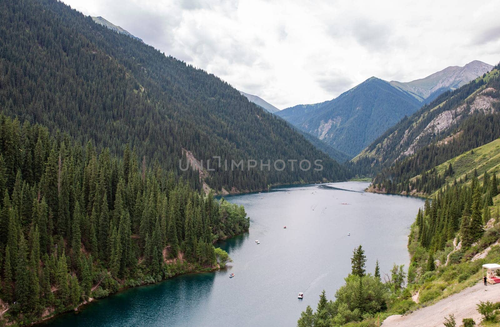 Pristine mountain lake, hidden gem in nature. Perfect for outdoor enthusiasts photographers. Explore towering pines, serene waters.