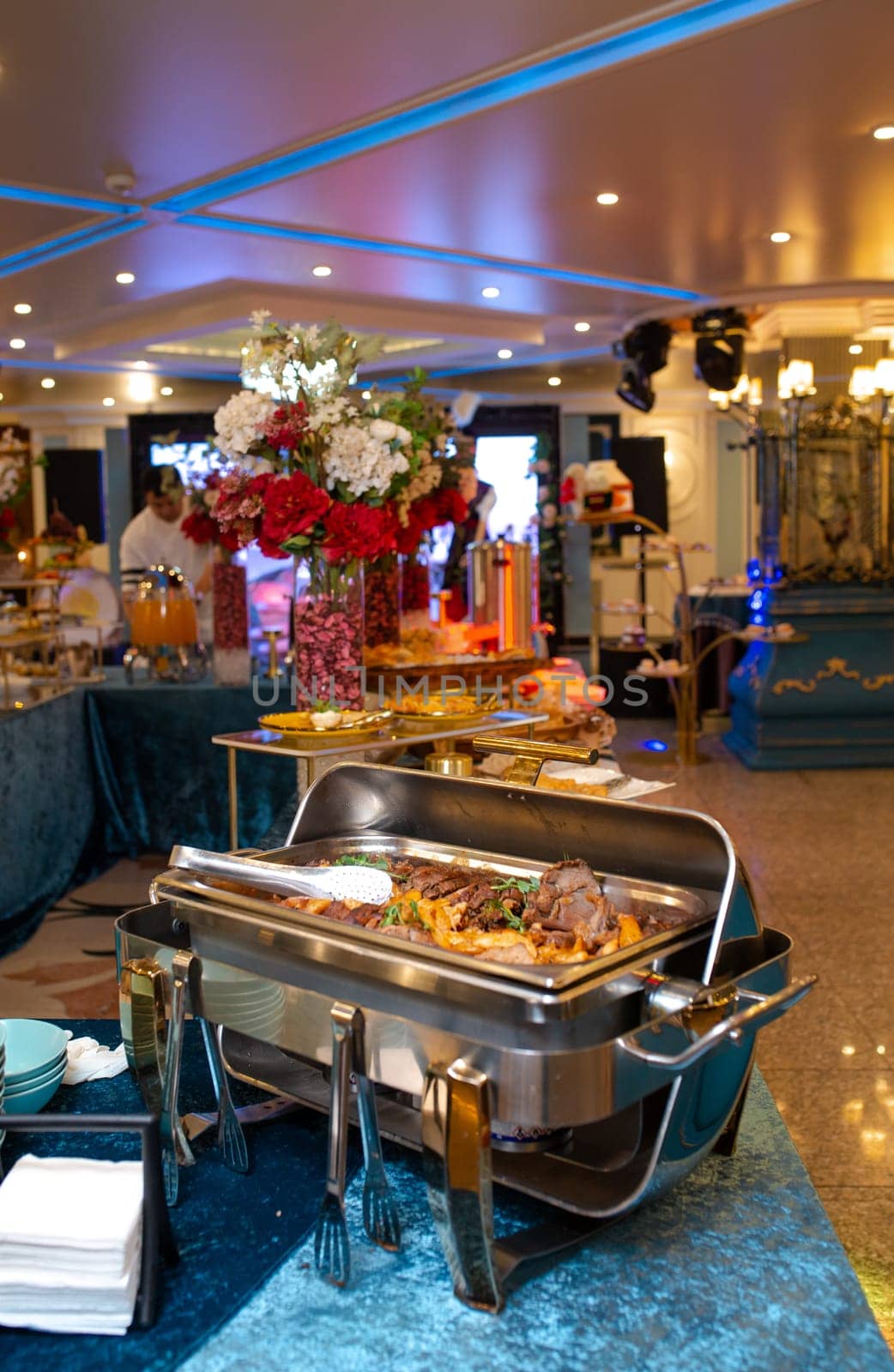 A buffet food warmer filled with delicious beef. The beef is cooked to perfection and is served with a variety of sauces and sides.