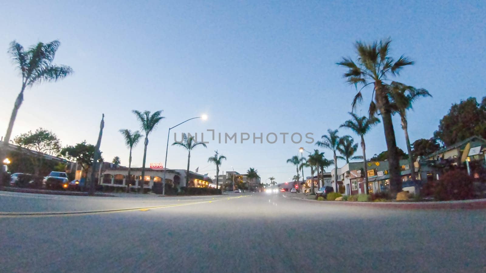 Los Angeles, California, USA-December 4, 2022-POV-As the sun sets, driving on HWY 101 near Pismo Beach, California becomes a captivating experience with the sky painted in shades of orange and pink, casting a warm glow over the coastal landscape.