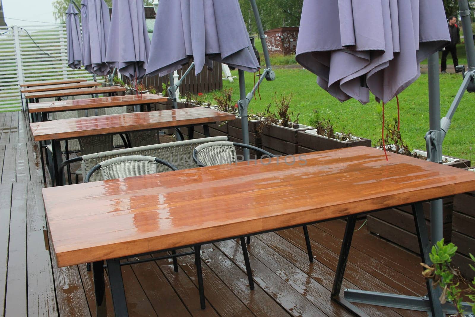 Photo after the rain, outdoor cafe tables. A closed restaurant. Outdoor playground.