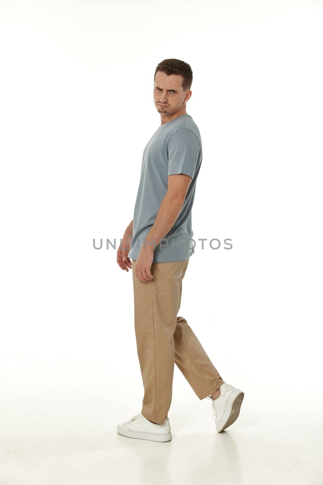 offended frustrated young man on white background. sadness
