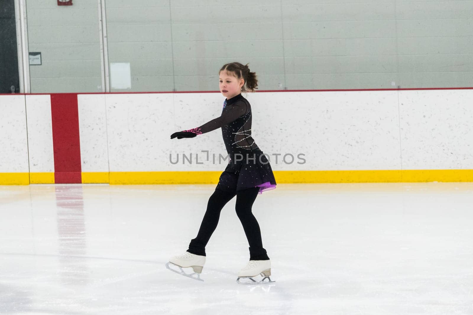 Figure skating practice at an indoor skating rink by arinahabich