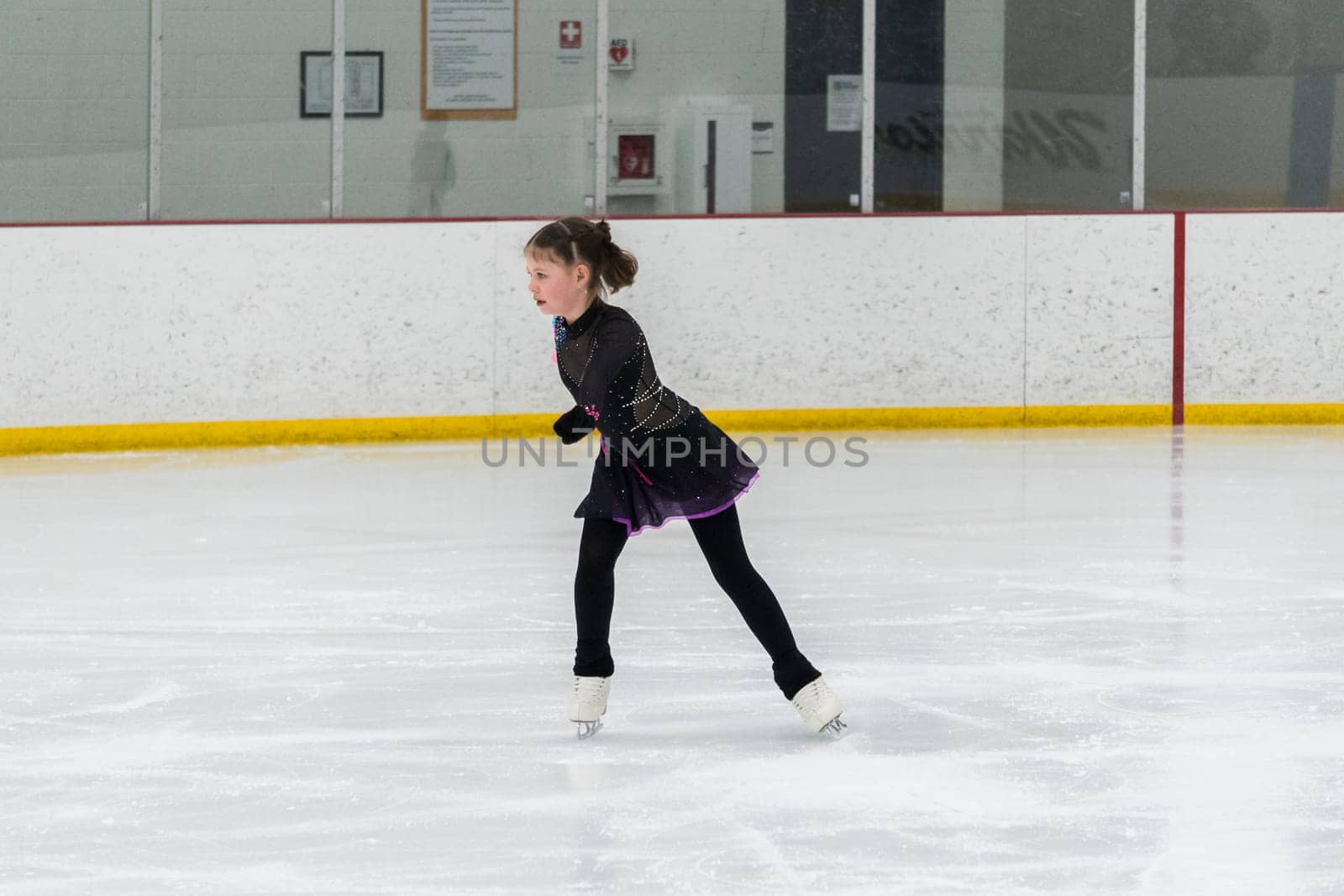 Figure skating practice at an indoor skating rink by arinahabich