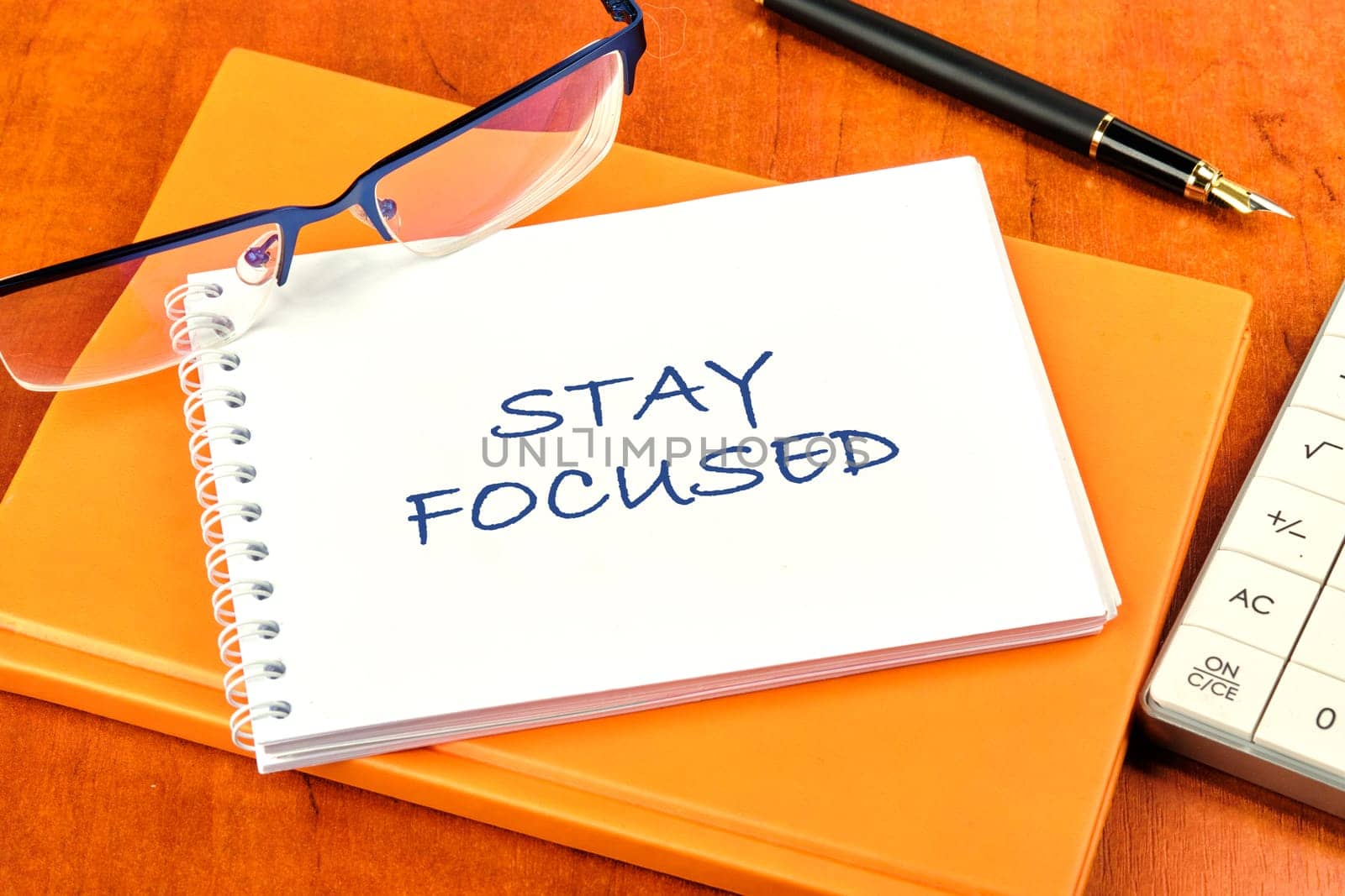 Motivation concept. STAY FOCUSED written on a clean white notebook