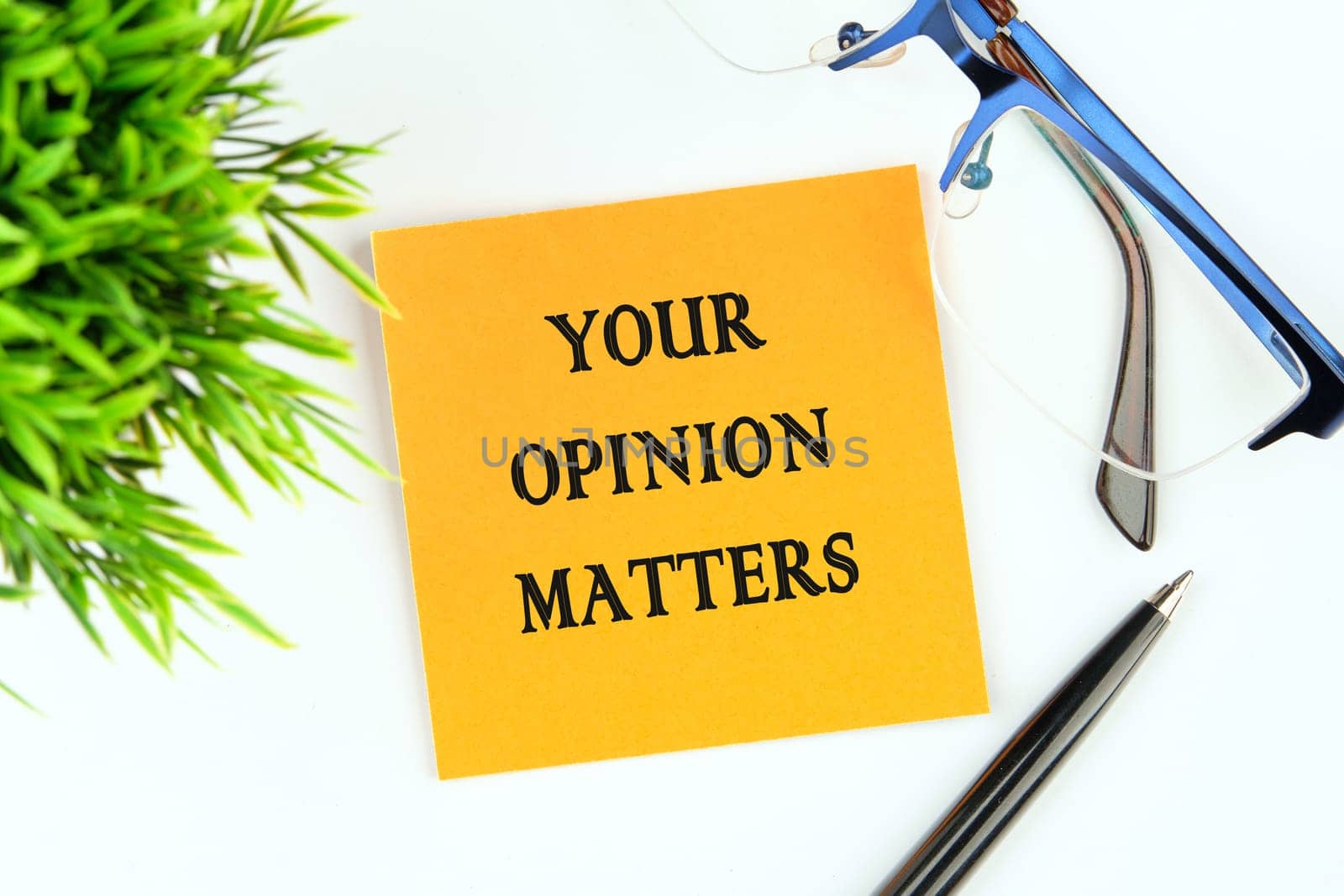 YOUR OPINION MATTERS phrase written on an orange sticker on a white background by Ihar