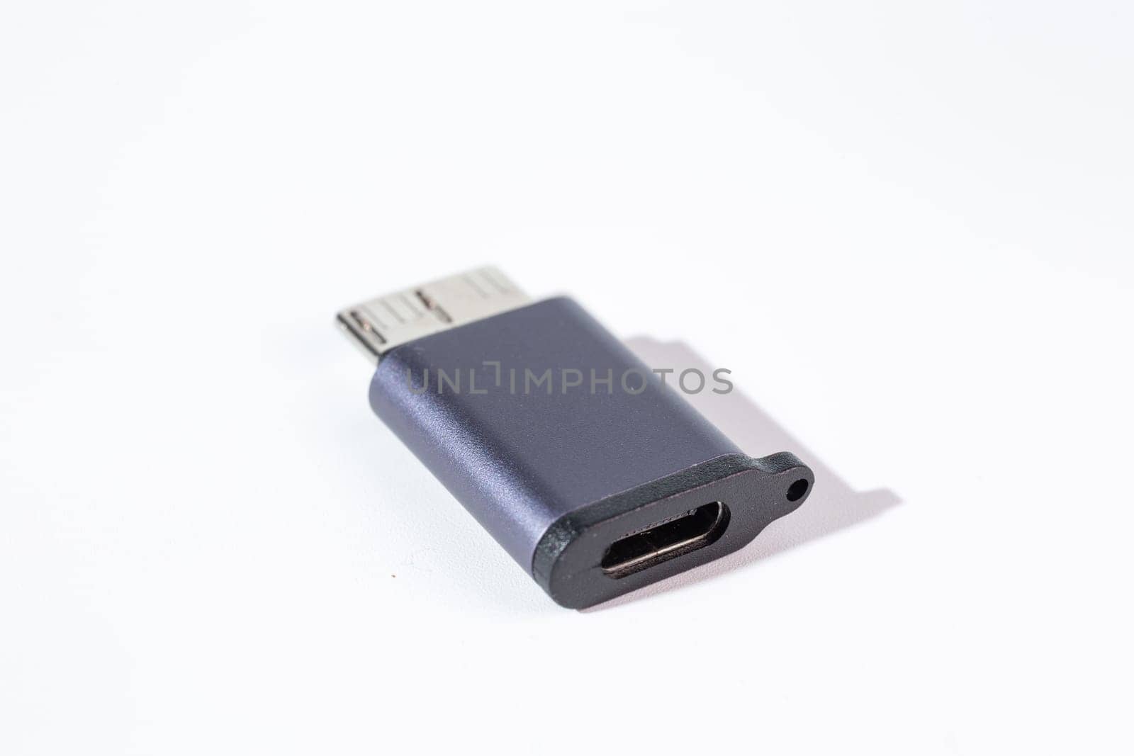 Isolated dark gray USB With HDD adapter on a white background. by Pukhovskiy