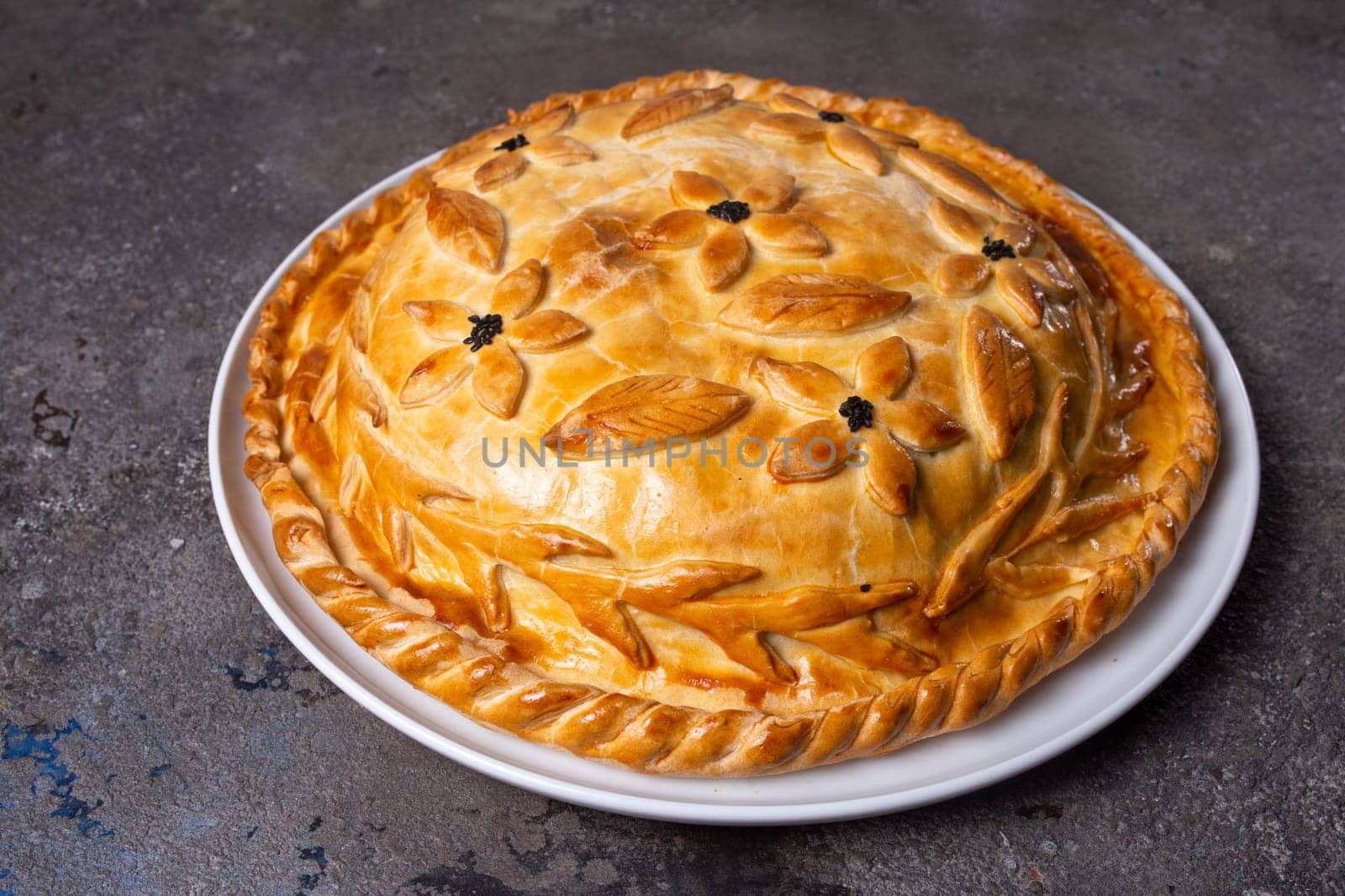 Rustic homemade round meat pie with golden crust, isolated on white background by Pukhovskiy