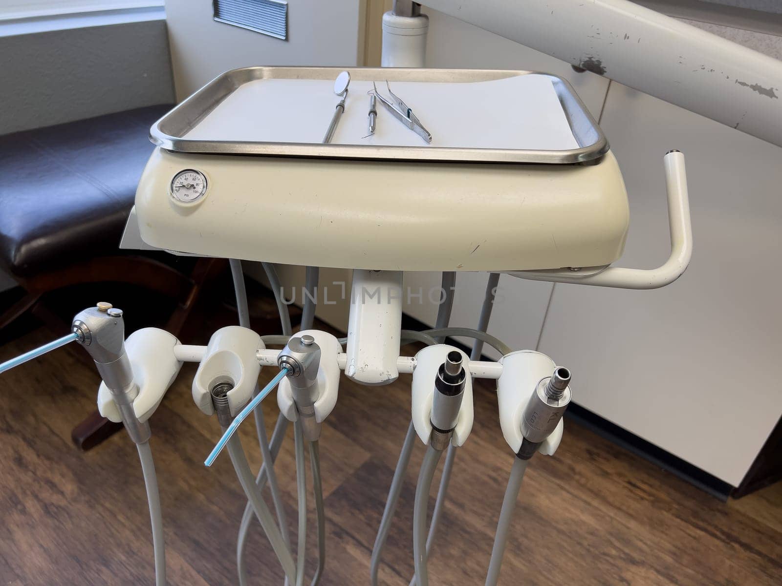 Denver, Colorado, USA-February 17, 2024- Essential tools of a dental workstation, featuring a traditional spit sink and an array of handpieces. The setup is indicative of a professional dental environment.
