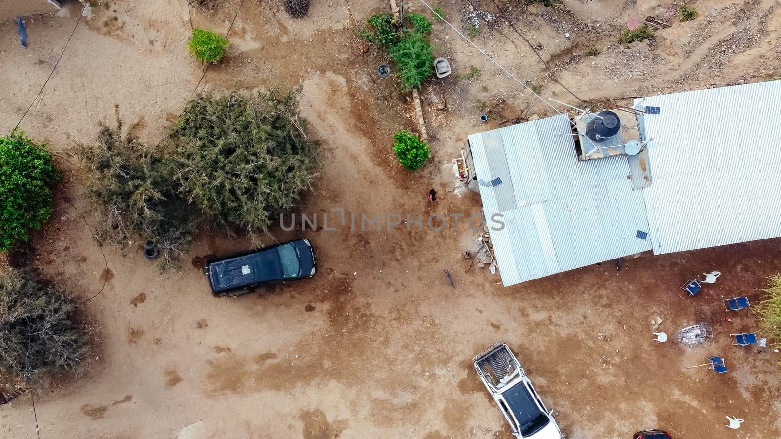 Aerial drone point of view of a rural house surrounded by countryside