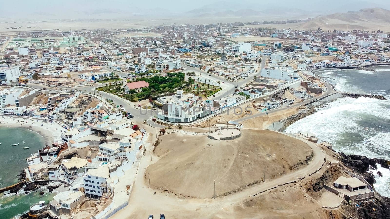 Aerial drone view of the cross from the viewpoint of the San Bartolo district by the sea