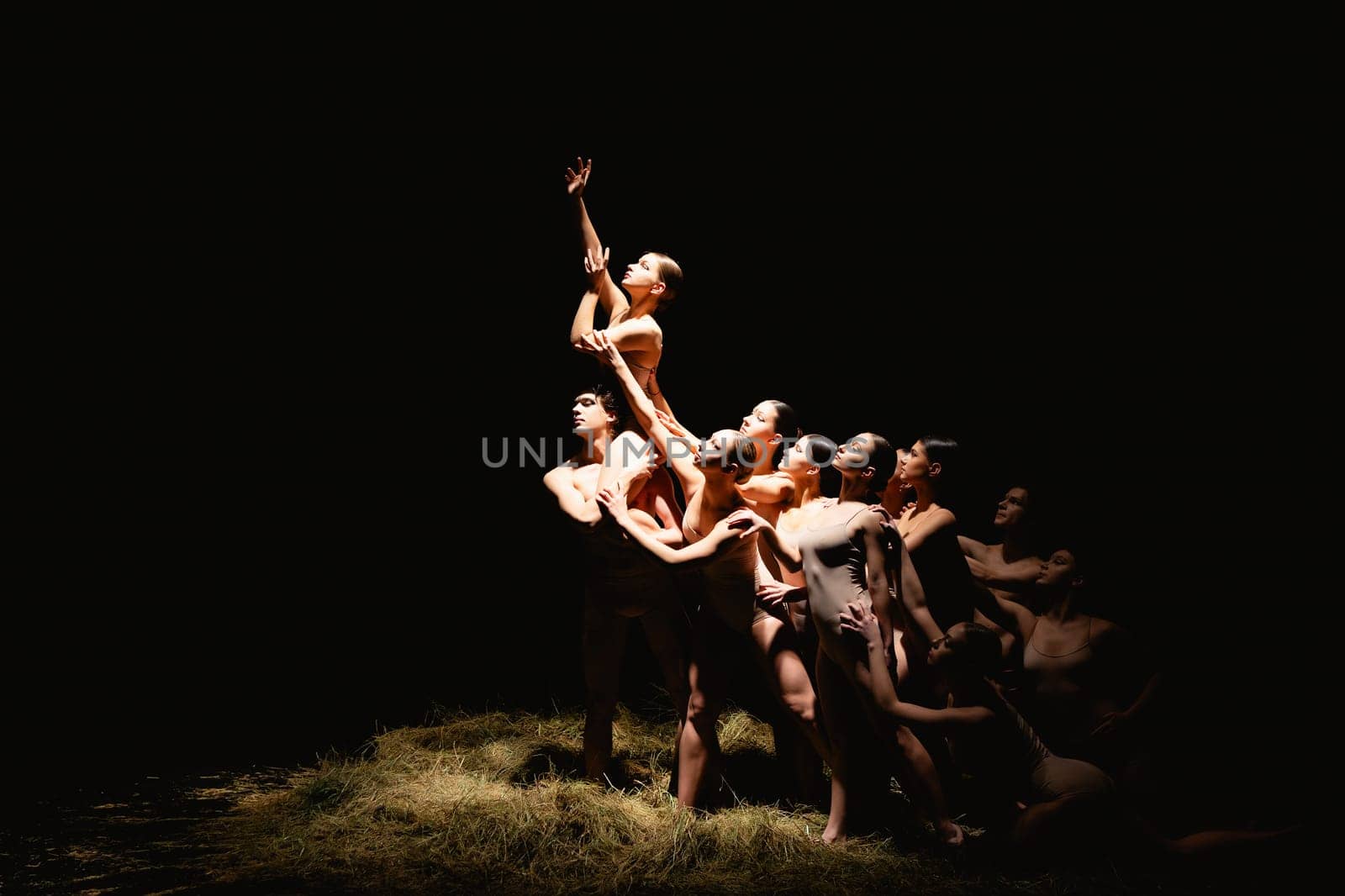 Group of modern ballet dancers. Contemporary art. Young flexible athletic men and women. Concept of dance grace, inspiration, creativity. Group of 11 models.