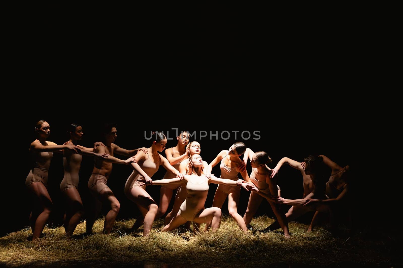 Group of modern ballet dancers. Contemporary art. Young flexible athletic men and women. Concept of dance grace, inspiration, creativity. Group of 11 models.