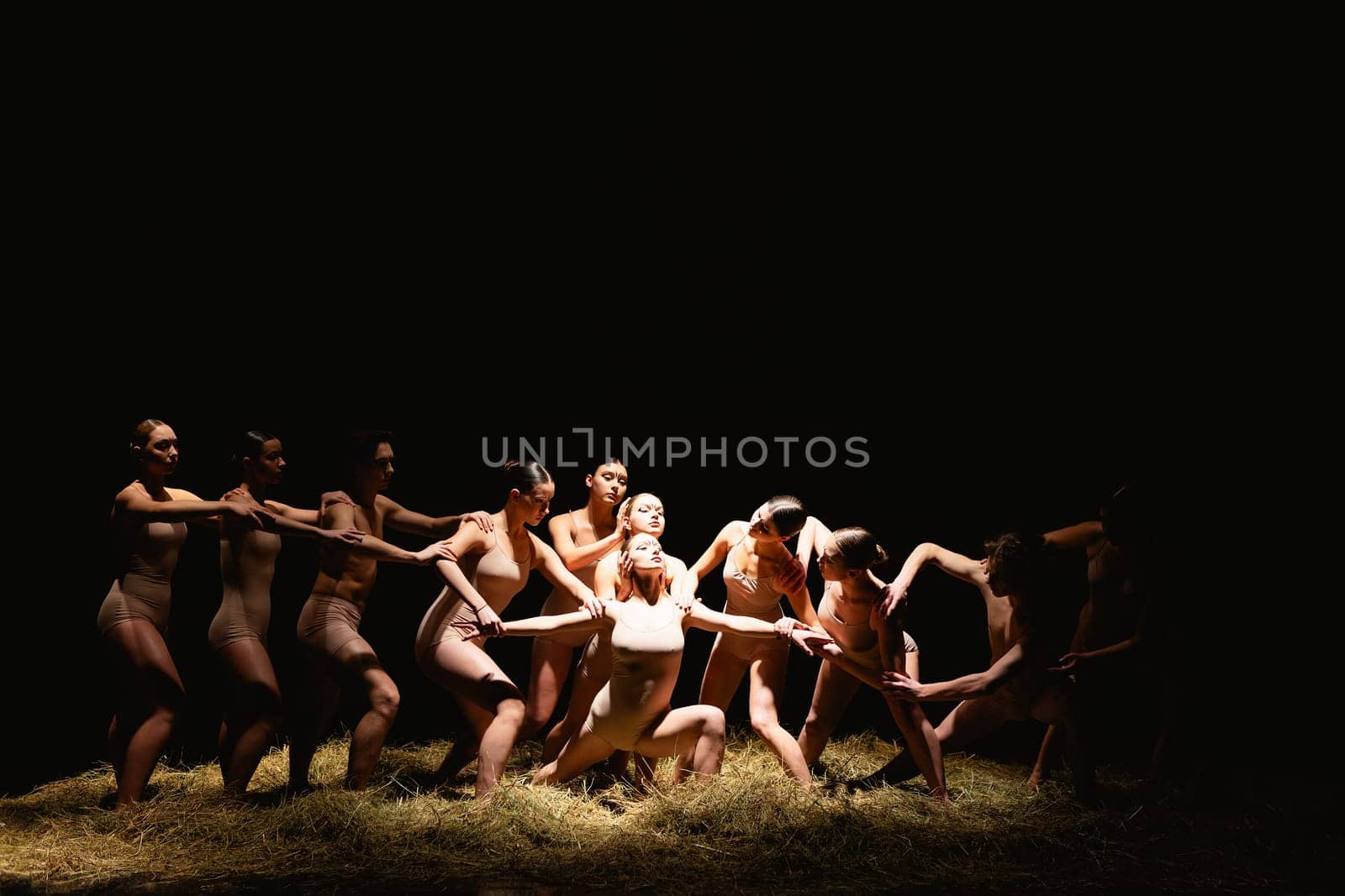 Group of modern ballet dancers. Contemporary art. Young flexible athletic men and women. Concept of dance grace, inspiration, creativity. Group of 11 models.