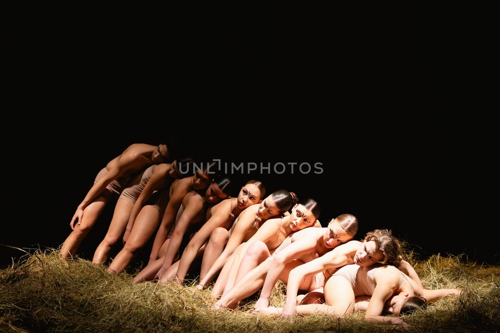 Group of modern ballet dancers. Contemporary art. Young flexible athletic men and women. Concept of dance grace, inspiration, creativity. Group of 11 models.