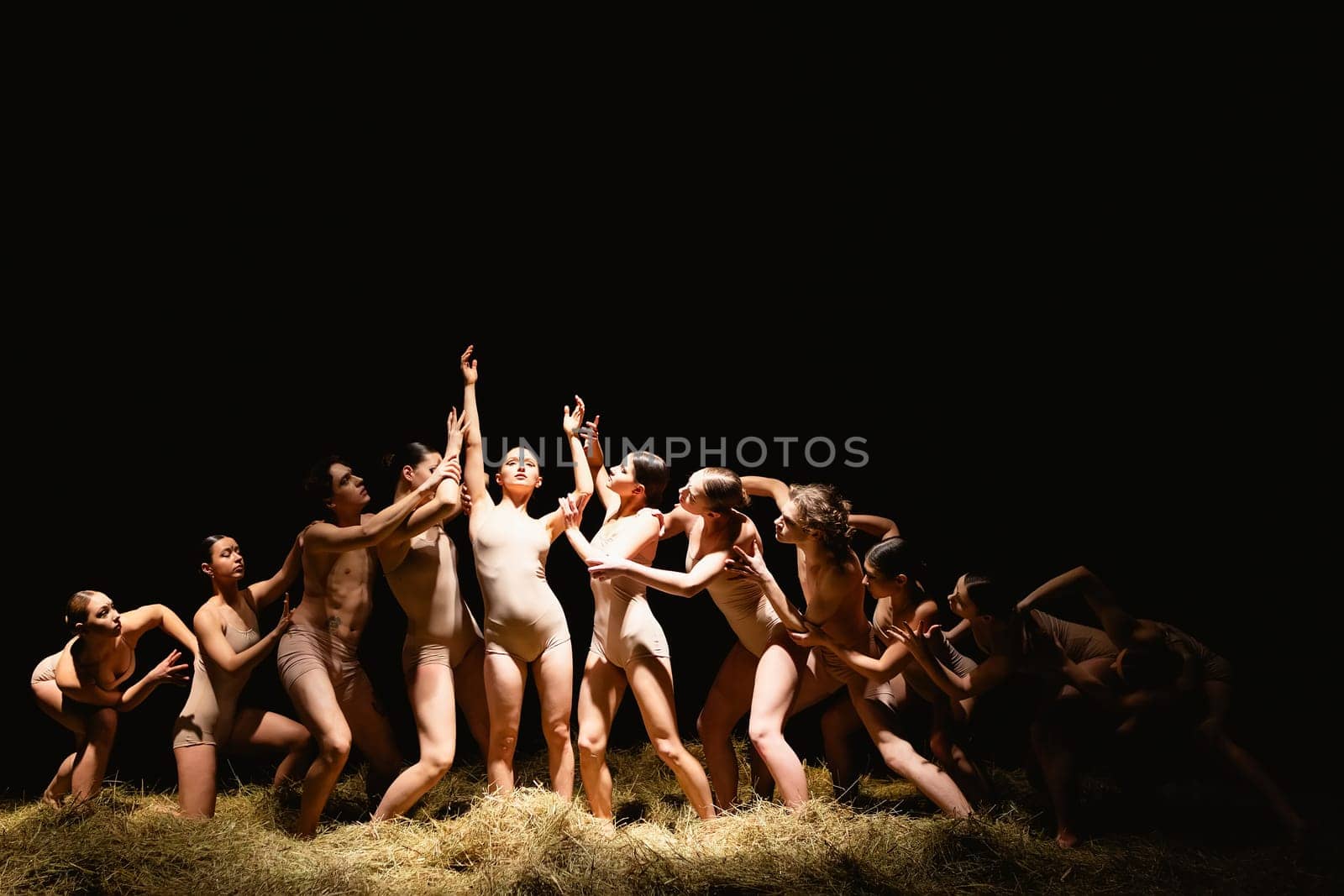 Group of modern ballet dancers. Contemporary art. Young flexible athletic men and women. Concept of dance grace, inspiration, creativity. Group of 11 models.