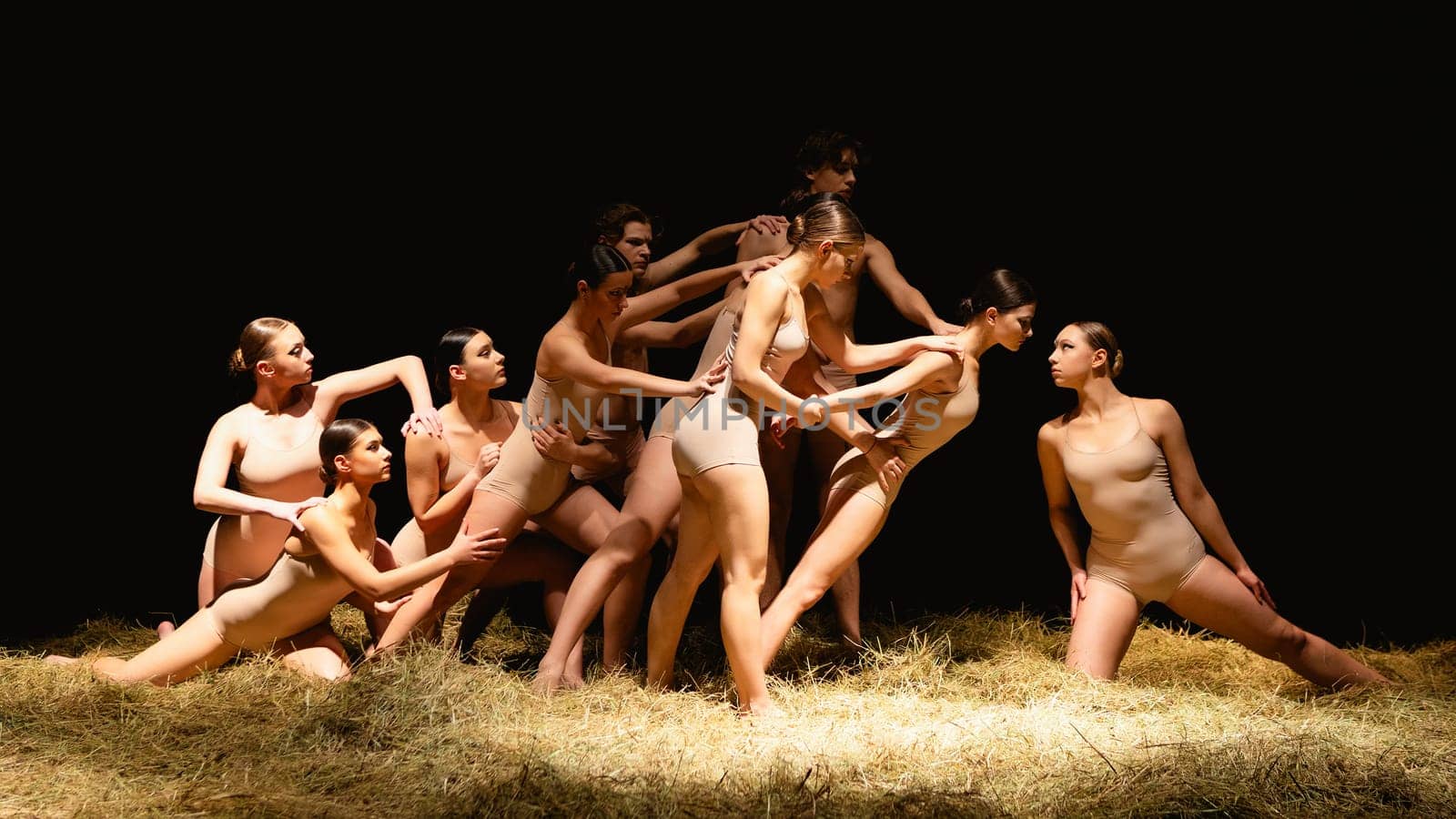 Group of modern ballet dancers. Contemporary art. Young flexible athletic men and women. Concept of dance grace, inspiration, creativity. Group of 11 models.