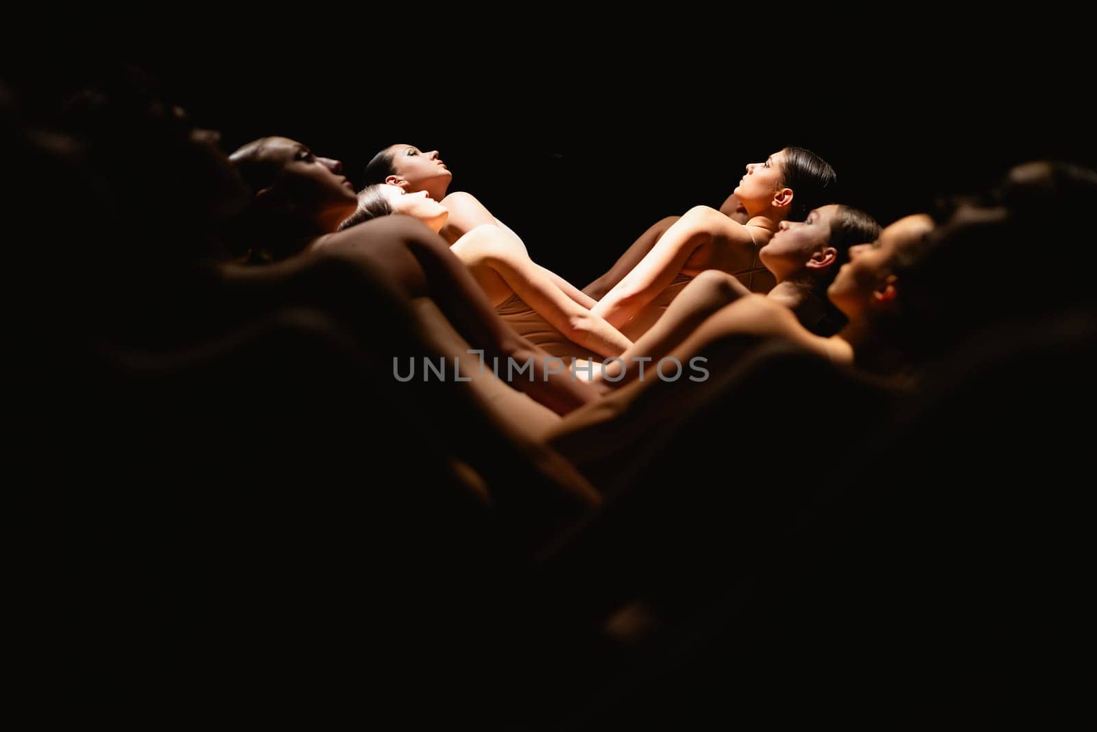 Group of modern ballet dancers. Contemporary art. Young flexible athletic men and women. Concept of dance grace, inspiration, creativity. Group of 11 models.