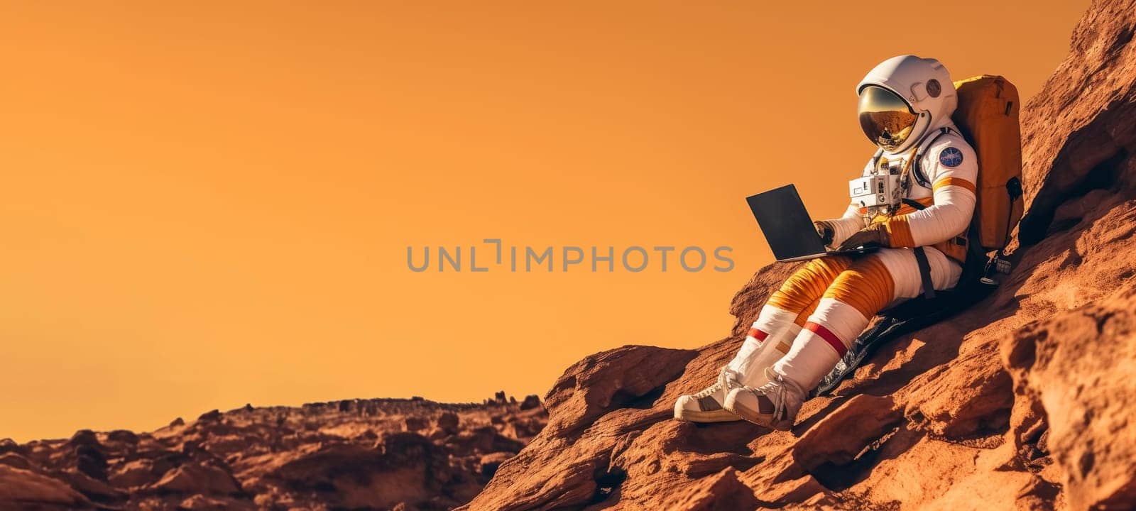 Astronaut with laptop sitting on rocky Mars-like terrain. by andreyz