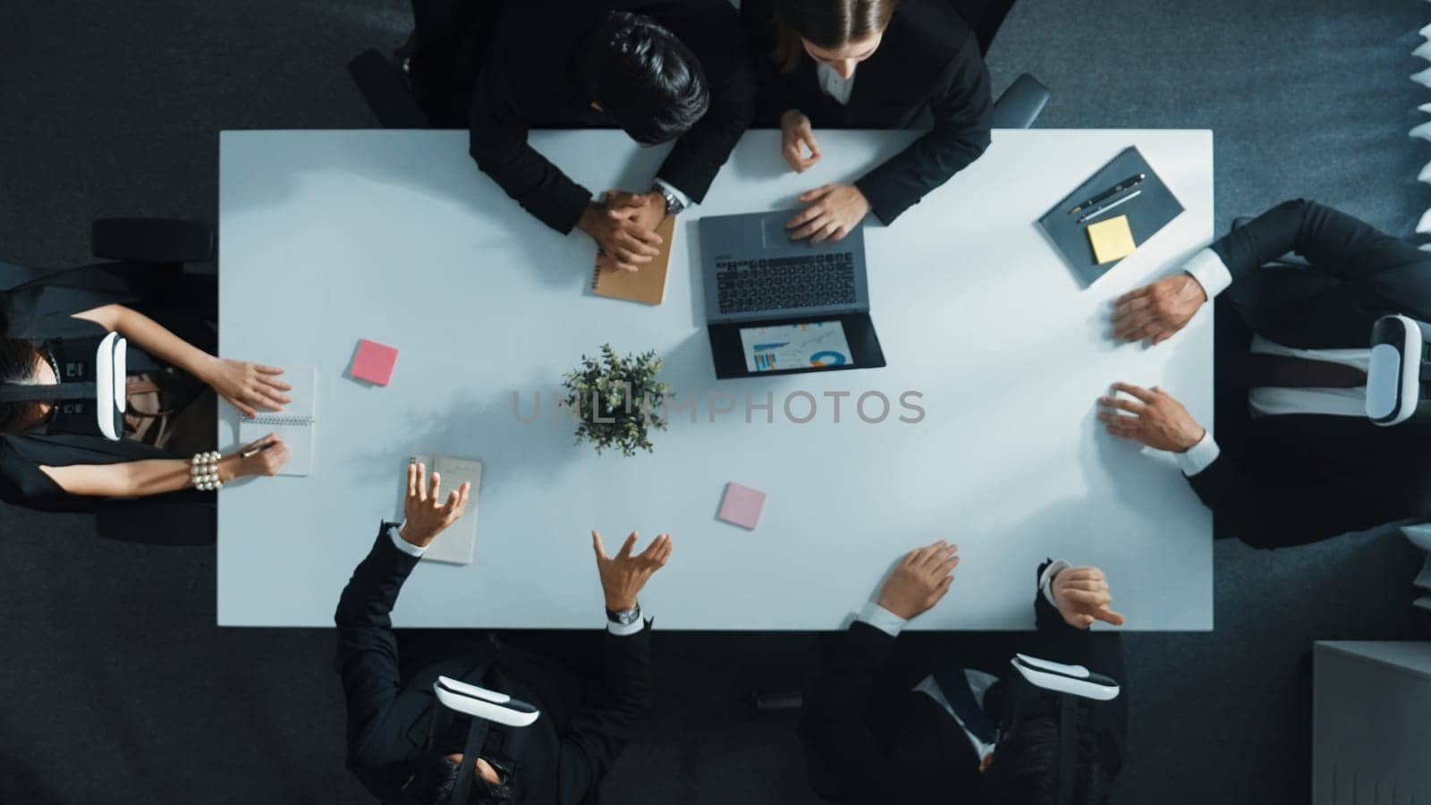 Top view of smart manager give vr head set to businesspeople while businesswoman prepare data analysis or analytic graph in laptop at meeting. Startup team preparing to enter meta verse. Directorate.