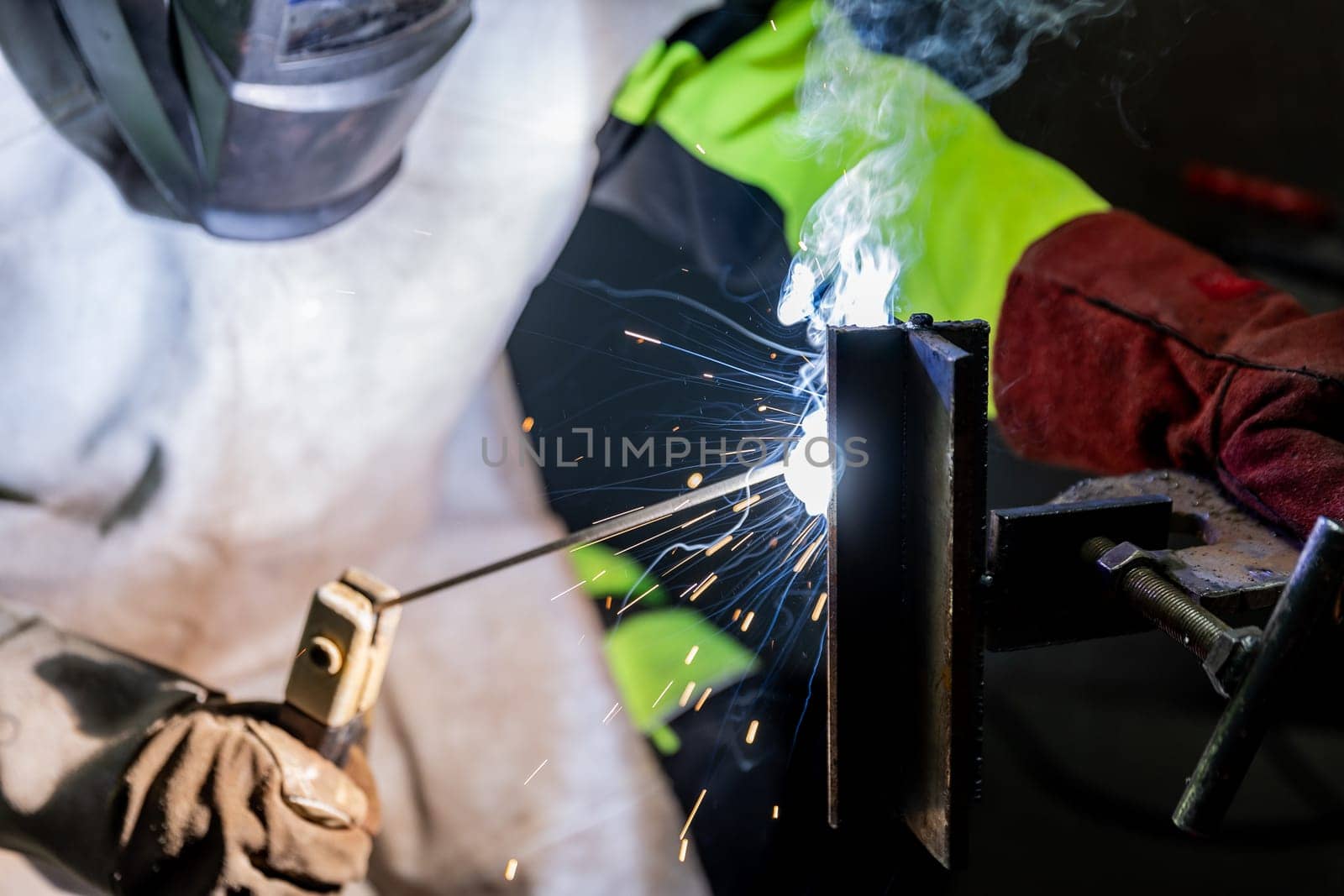 Industry worker welding a pieces of metal in a factory, weld concept