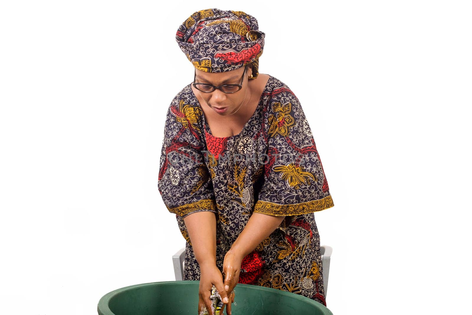 African woman washing clothes at home by vystek