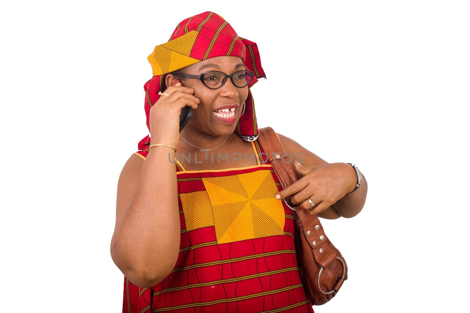 mature woman in loincloth standing on white background communicating on mobile phone smiling.